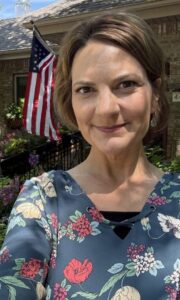 Suzanne Haag Photo of Suzanne Haag, marketing & outreach director, standing outside the beautiful Gianna Homes residence in Minnetonka